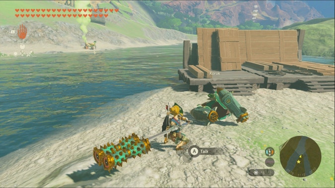 A screenshot of The Legend of Zelda: Tears of the Kingdom. A Korok has 3 missiles attached to it and is aimed at its friend across the shore. Link is about to strike it with a weapon.